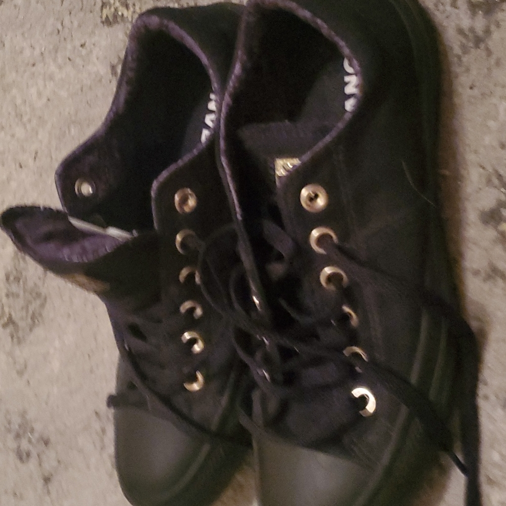 Black and gold low top converse